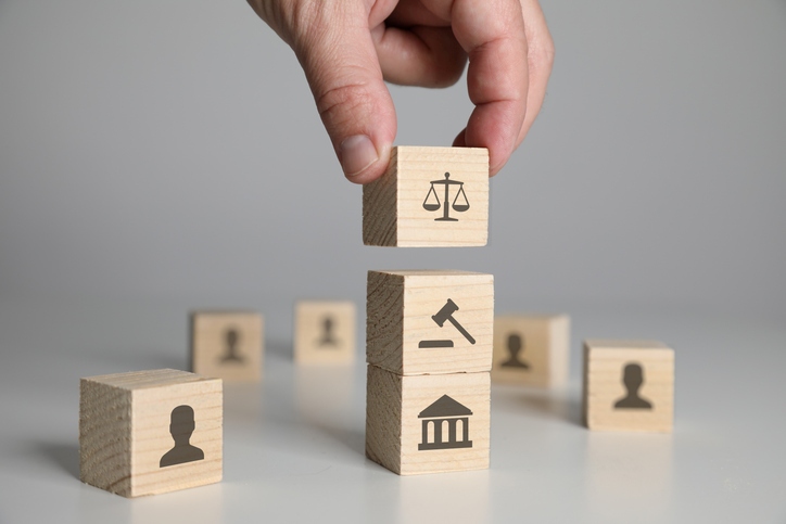 A hand placing a block on top of a stack of wooden blocks
AI-generated content may be incorrect.